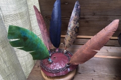 Feather display in handmade copper and wood stands